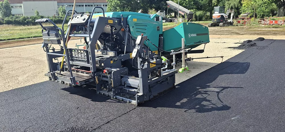 Machine de pose d'enrobé FCBE utilisée pour les travaux de voirie, terrassement et aménagement extérieur dans le Jura